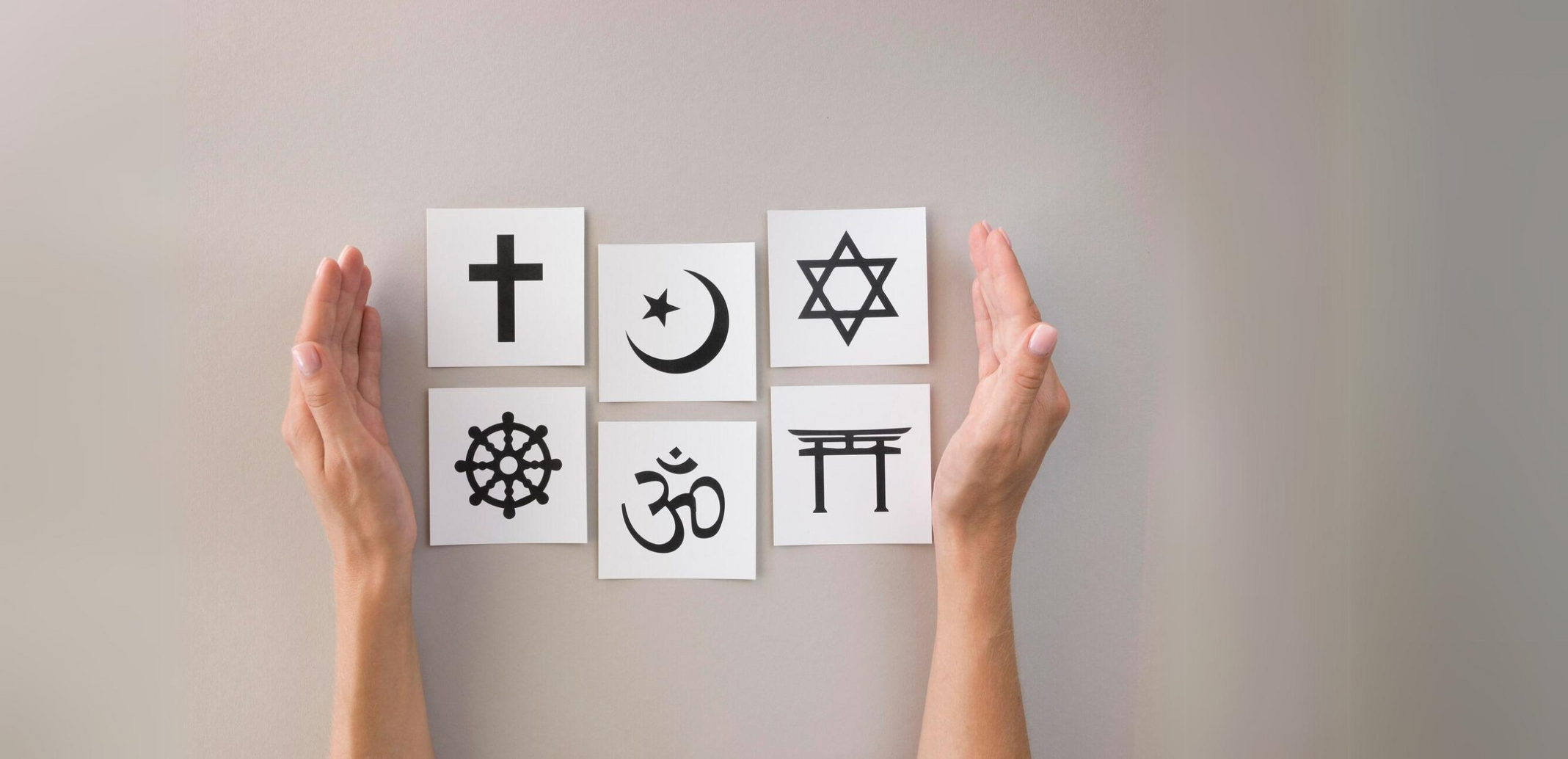 a person holding up a piece of paper with religious symbols on it